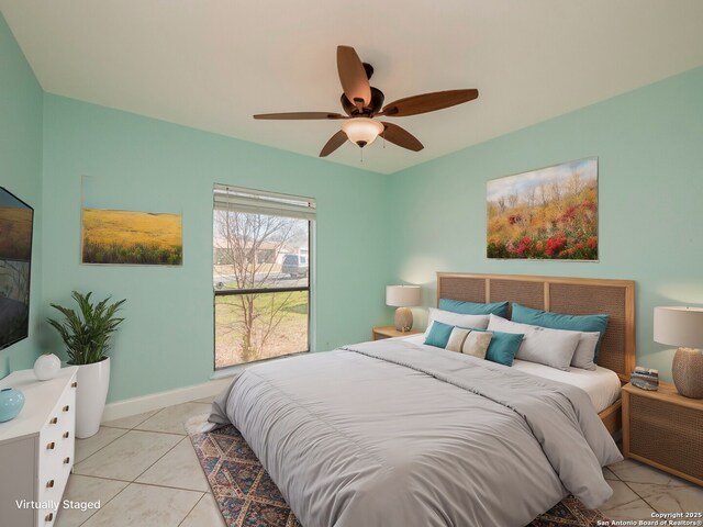 bedroom with light tile patterned floors, baseboards, and a ceiling fan