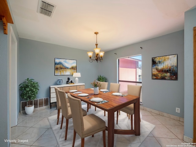 dining room featuring baseboards, visible vents, a notable chandelier, and light tile patterned flooring