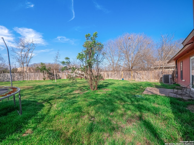 view of yard with a patio area, a fenced backyard, a trampoline, and cooling unit