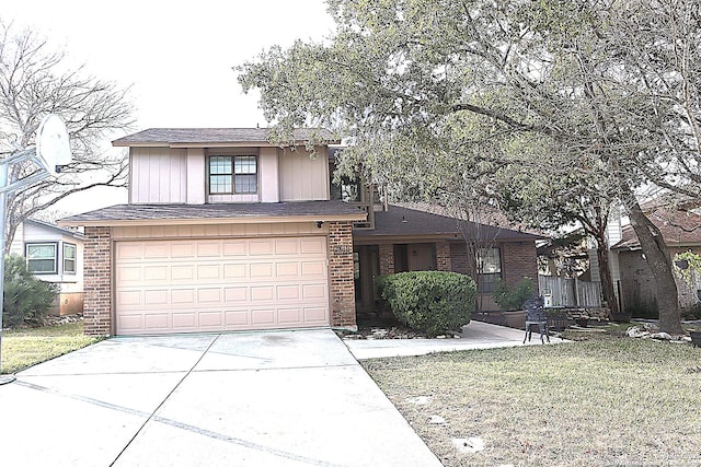 view of front facade featuring a garage, a front yard, concrete driveway, and brick siding