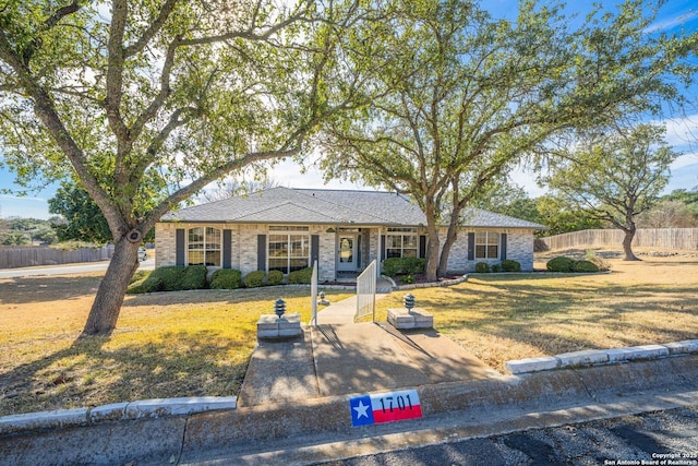 view of front of home featuring a front yard and fence