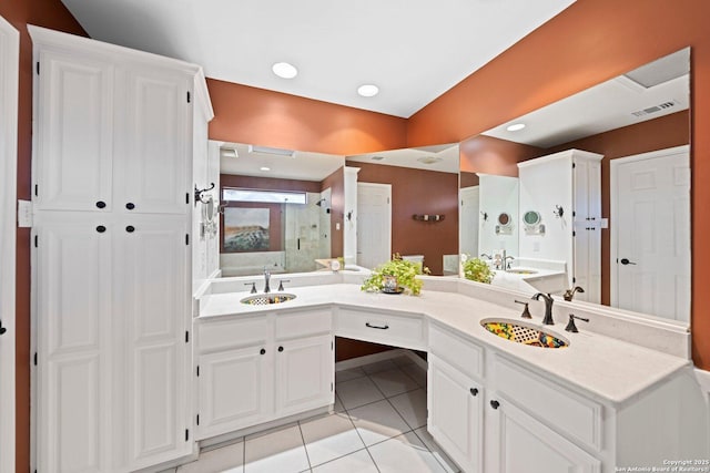 full bathroom with a stall shower, tile patterned flooring, a sink, and visible vents