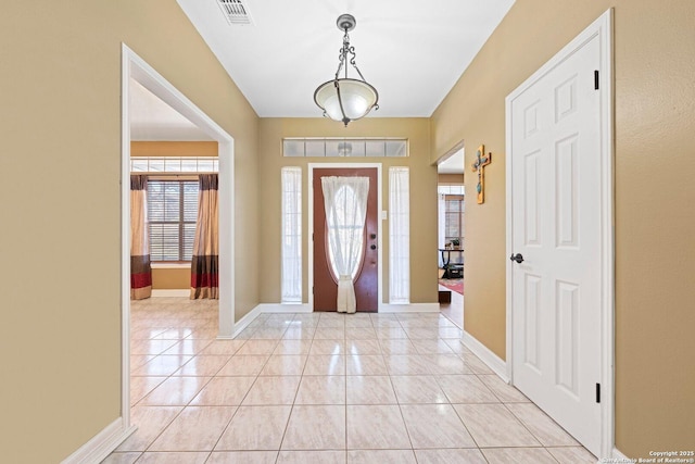 entrance foyer with light tile patterned floors, visible vents, and baseboards