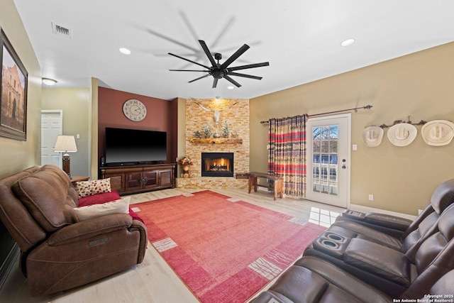 living room with a fireplace, recessed lighting, visible vents, a ceiling fan, and wood finished floors