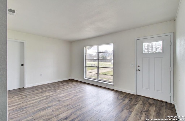 entryway featuring visible vents, baseboards, and wood finished floors