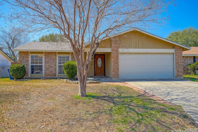 single story home with a garage, driveway, and brick siding