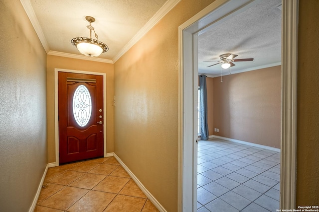 entryway featuring light tile patterned floors, a textured ceiling, baseboards, and crown molding