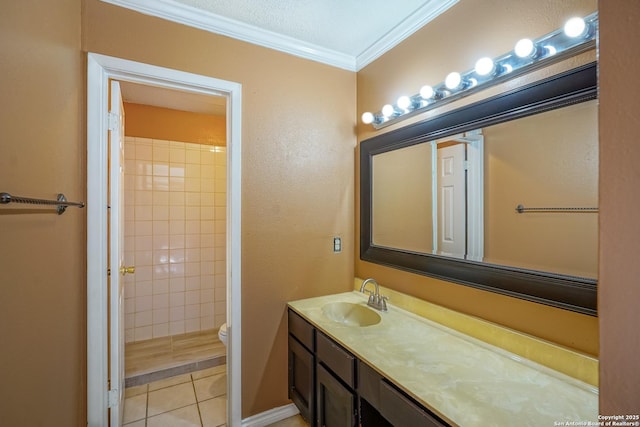 bathroom with toilet, ornamental molding, tile patterned flooring, a tile shower, and vanity