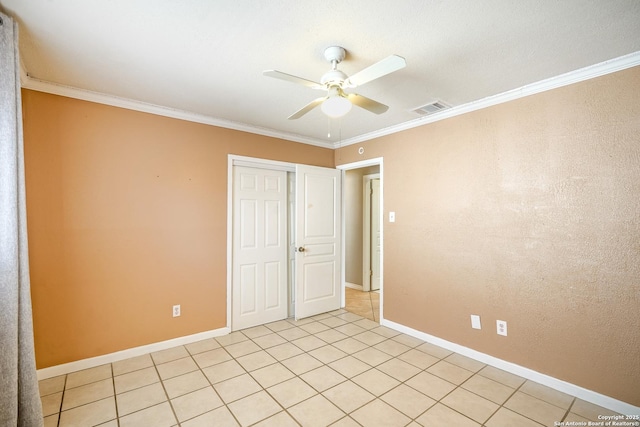 unfurnished bedroom featuring baseboards, visible vents, a closet, and ornamental molding