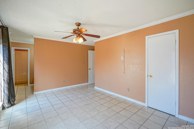 empty room featuring ornamental molding, baseboards, and a ceiling fan