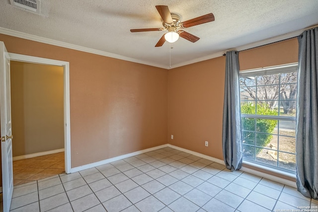 spare room with a textured ceiling, visible vents, crown molding, and light tile patterned flooring