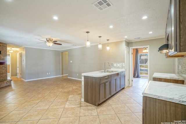 kitchen featuring a ceiling fan, a sink, under cabinet range hood, and light tile patterned floors