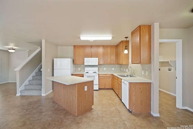 kitchen featuring white appliances, tasteful backsplash, a kitchen island, light countertops, and a sink