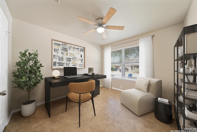 home office featuring ceiling fan, light tile patterned floors, and baseboards