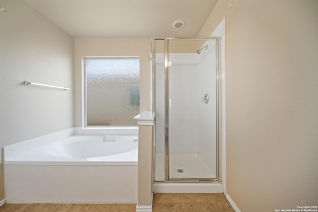 full bath with a stall shower, tile patterned flooring, and a garden tub