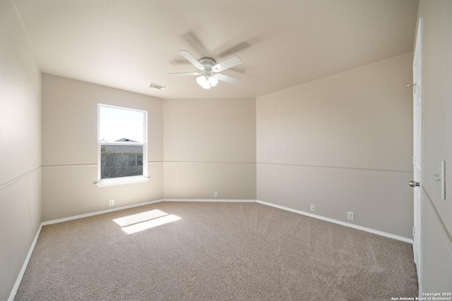 carpeted empty room with a ceiling fan, visible vents, and baseboards