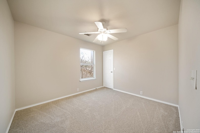 unfurnished room featuring baseboards, a ceiling fan, and light colored carpet