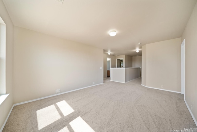 unfurnished room with carpet floors and baseboards