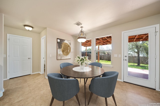 dining room featuring light tile patterned floors, baseboards, and visible vents