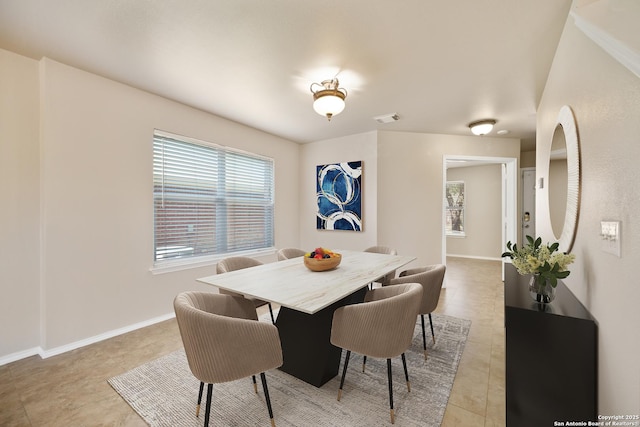 dining room with visible vents, baseboards, and light tile patterned floors