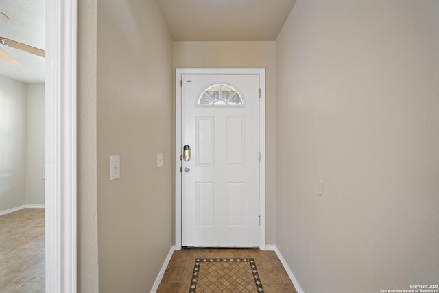 entryway with tile patterned floors and baseboards