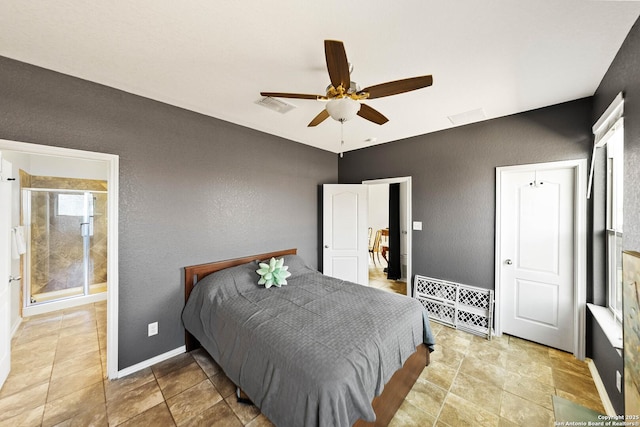 bedroom with baseboards, visible vents, a textured wall, ensuite bath, and ceiling fan