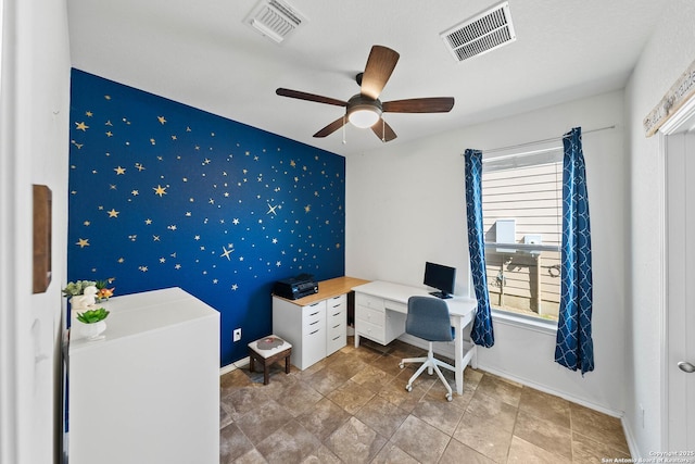 home office with an accent wall, visible vents, baseboards, and wallpapered walls