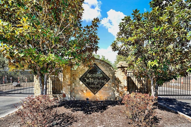 community sign with a gate and fence