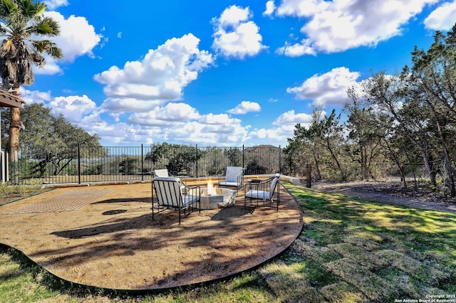 view of yard featuring fence and a fire pit