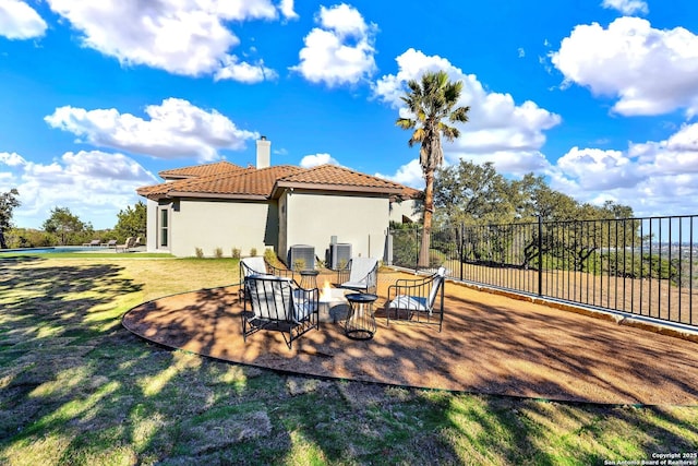 exterior space with central AC unit and fence