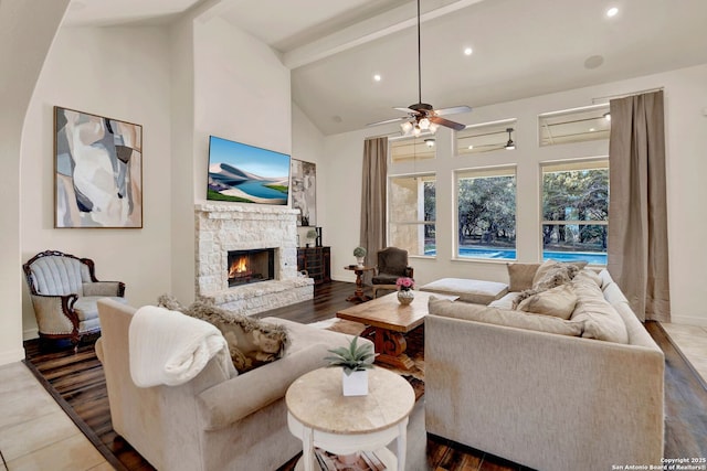 living room featuring high vaulted ceiling, recessed lighting, a fireplace, and beamed ceiling