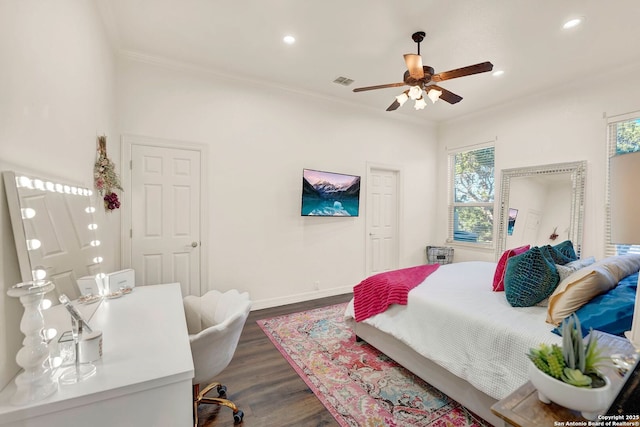 bedroom with baseboards, visible vents, ornamental molding, and dark wood-style flooring