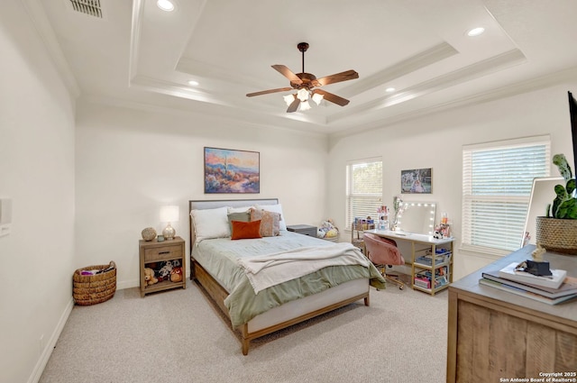 bedroom featuring light carpet, visible vents, a tray ceiling, and ornamental molding