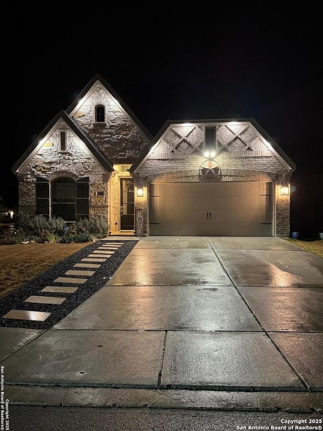 view of front facade featuring stone siding, concrete driveway, an attached garage, and brick siding