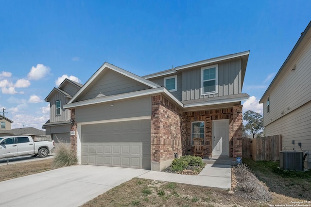 4874 Nueces Path, San Antonio, TX 78253 - view of front of property with central air condition unit, driveway, fence, board and batten siding, and brick siding