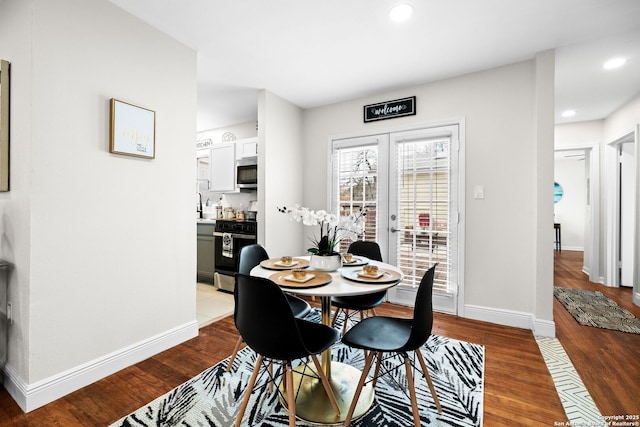 dining area with recessed lighting, baseboards, wood finished floors, and french doors