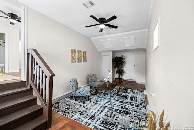 interior space with a ceiling fan, visible vents, vaulted ceiling, and stairs