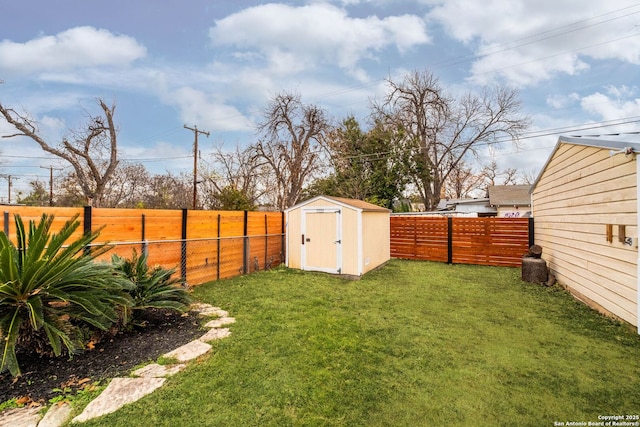 view of yard featuring an outbuilding, a fenced backyard, and a shed