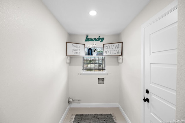 laundry area featuring laundry area, light tile patterned flooring, hookup for a washing machine, and baseboards