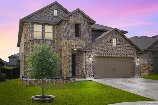 view of front of property with brick siding, concrete driveway, a garage, stone siding, and a front lawn