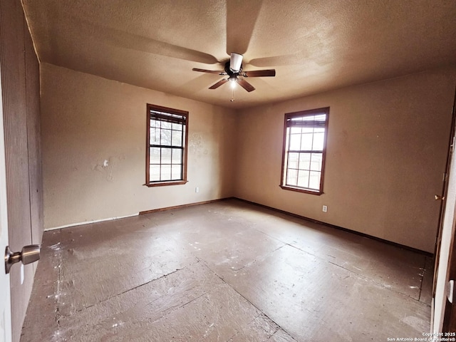 unfurnished room featuring a textured ceiling, baseboards, and a ceiling fan
