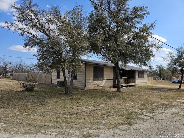 view of front of house featuring crawl space, fence, and cooling unit