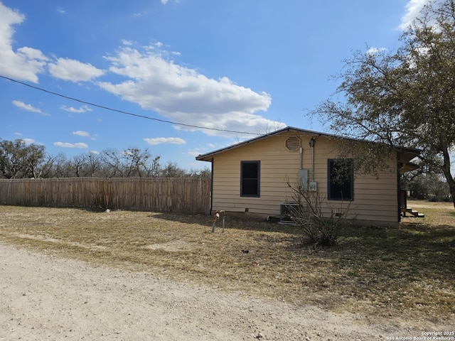 view of side of home with fence