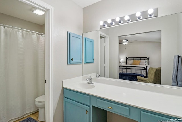 full bathroom with toilet, connected bathroom, a ceiling fan, and vanity