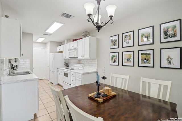 dining space featuring visible vents, an inviting chandelier, and light tile patterned floors