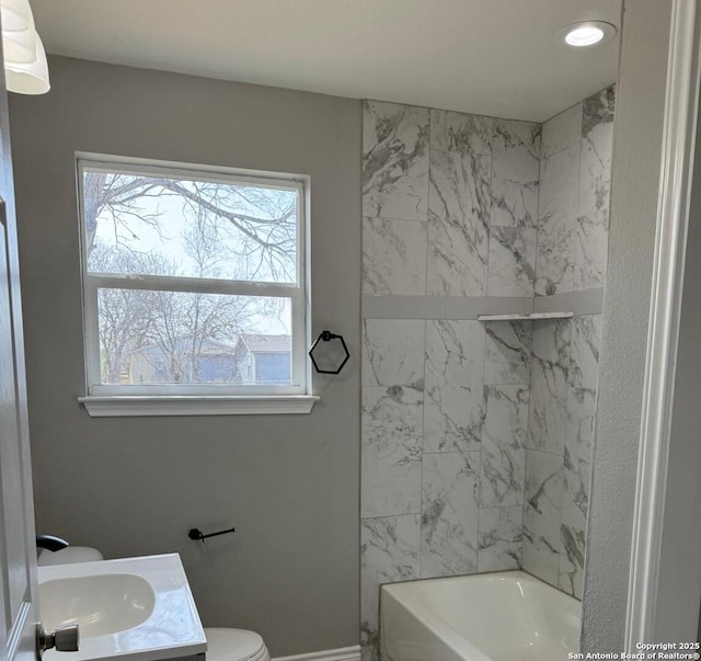 bathroom with vanity, toilet, and bathing tub / shower combination