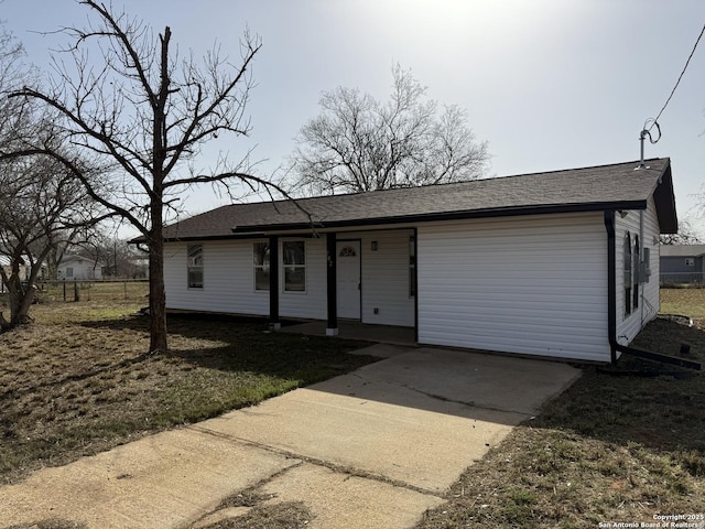 ranch-style home with fence and roof with shingles