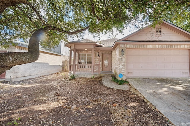 single story home with a garage, brick siding, and driveway