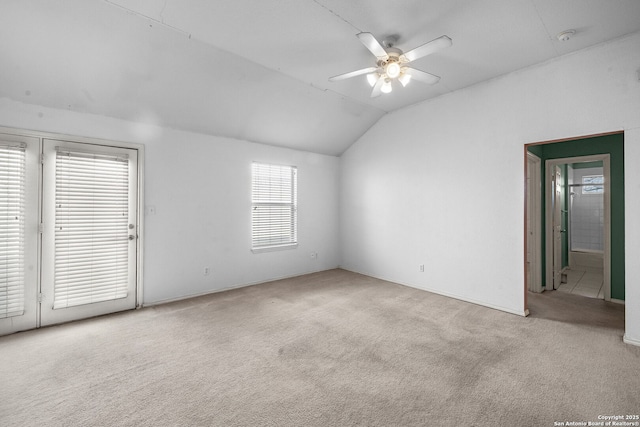 carpeted spare room with lofted ceiling and ceiling fan