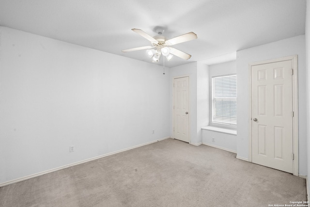 unfurnished bedroom featuring ceiling fan, carpet floors, and baseboards